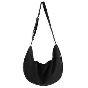 Large black crescent oxford nylon crossbody bag with adjustable wide strap and metal buckle