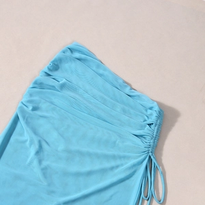 Close-up of blue mesh fabric featuring detailed side drawstring ruching and gathered texture