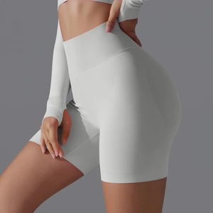 Detail of high-waist ribbed yoga shorts and long sleeve crop top with thumb holes