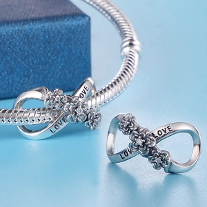 Silver infinity charm with crystal flowers and LOVE engraving on snake chain bracelet