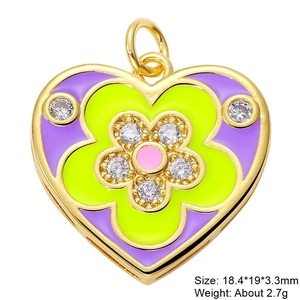 Macro detail of heart-shaped pendant with purple enamel flower and cubic zirconia