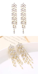 Close-up of golden tassel drop earrings with sparkling rectangular crystal stones