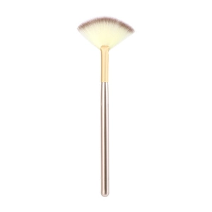 Detailed macro view of a golden handle fan brush with soft brown gradient bristles