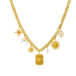 Vintage gold stainless steel necklace with sun, moon, and star pendants on white background