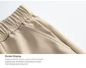 Detail of high elastic waistband and slanted pockets on beige cargo trousers