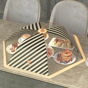 Collapsible striped mesh food cover in beige and black with cooking print and handle