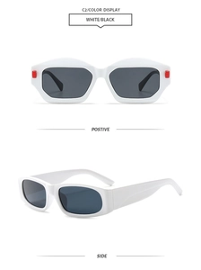 Detail view of white square sunglasses with red accents and dark lenses in outdoor style