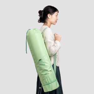 Light green yoga mat bag with drawstring closure and bottom wet pocket detail