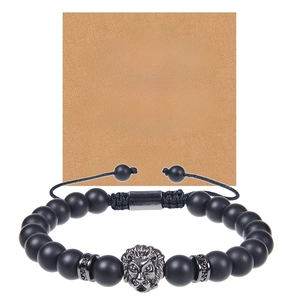 Close-up of black matte beaded lion head bracelet with greeting card for son