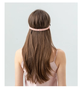 Pink 22 momme silk sleep mask with elastic strap shown on model for back fit and comfort