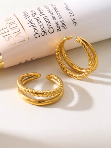 Detailed view of gold plated double-layer twist and smooth texture open design ring