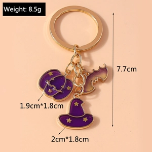 Detail of Halloween keychain with gold plating, purple pumpkin, bat and wizard hat charms