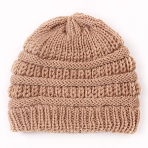 Close-up of light brown knitted baby hat featuring thick ribbed texture and warm winter yarn