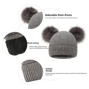 Detail view of winter knitted hat featuring dual faux fur pom-poms and warm fleece lining