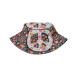 Detailed close-up of a floral bucket hat featuring a bold black letter logo on fabric
