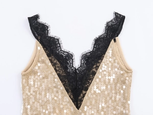 Detailed view of the V-neckline featuring black eyelash lace and shiny gold sequins