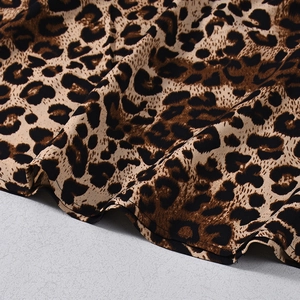 Macro shot of leopard print skirt hem showing fine stitching and lightweight fabric texture