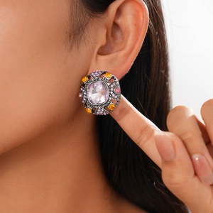 Macro detail of vintage geometric earring with purple rhinestones on a female model
