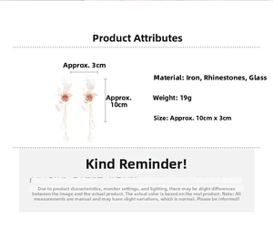 Detailed view of white flower tassel earrings with red rhinestone and glass drop pendant