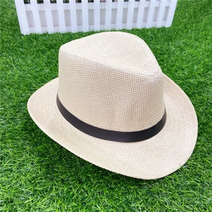 Close-up of beige straw fedora hat featuring tight cross-weave texture and black band