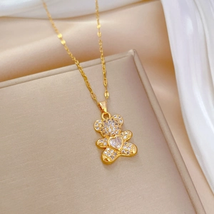 Luxurious gold bear necklace with sparkling white zircons and heart-shaped center stone