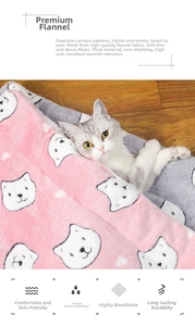 Close-up of thick pink flannel pet blanket with cartoon cat print for warm winter bedding