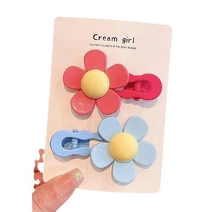 Pink and light blue flower hair clips for girls set on a cream display card