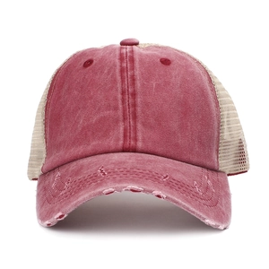 Detailed macro view of distressed washed cotton texture and mesh back on the baseball cap