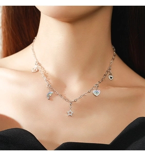 Close-up of S925 silver necklace with heart, rainbow, and star pendants on a model