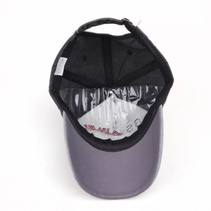 Detail view of cotton baseball cap interior featuring embroidery and metal buckle strap