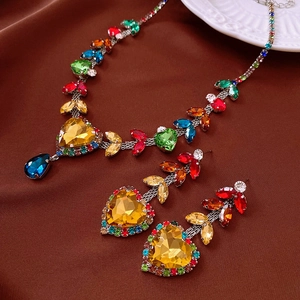 Macro view of multicolor gemstone jewelry set featuring heart-shaped yellow crystals