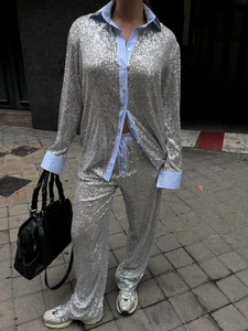 Street view of a shimmering silver sequin loose blazer and wide-leg trousers two-piece set