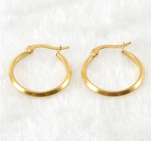 Detail of 18K gold stainless steel hoop earrings with unique angular faceted surfaces