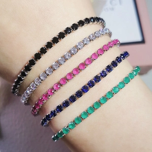Close-up of five colorful zircon tennis bracelets in black, pink, blue, and green colors