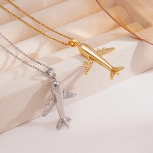 Fashionable airplane pendant necklace set in gold and silver finish with zircon stones