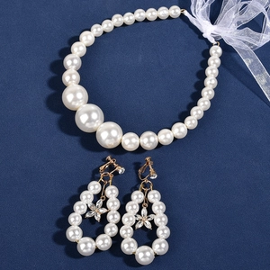 Elegant white pearl jewelry set with beaded necklace, ribbon and floral hoop earrings
