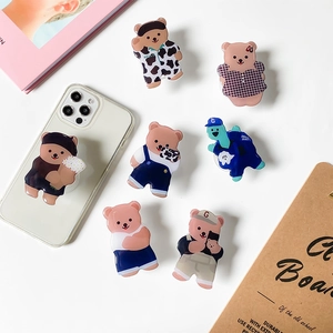 Cute cartoon bear expandable phone socket stand with various stylish outfits in brown and pink