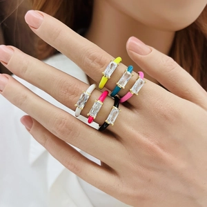 Close-up of colorful enamel teardrop rings with cubic zirconia inlay on a model hand