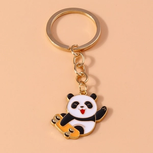 Close-up of cute cartoon panda on a skateboard keychain with orange enamel detail