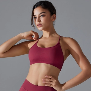 Close-up of seamless burgundy yoga bra with ribbed hem and cross-back straps detail