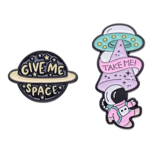 Cartoon astronaut and UFO enamel pin set featuring Give Me Space and Take Me slogans