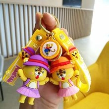 Dettaglio di portachiavi a forma di tigre cartone animato in abiti viola e arancione con laccio