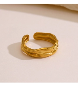 Detail of gold irregular textured ring with lava surface and adjustable open design