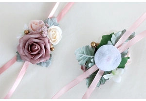 Detailed view of pink and ivory rose wrist corsage with silk ribbons for weddings