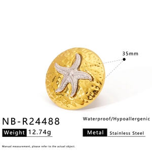 Detail showing 35mm stainless steel gold disc with silver starfish and hammered texture