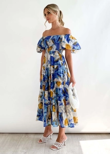 Detail of blue floral off-shoulder maxi dress with puff sleeves and layered ruffle skirt