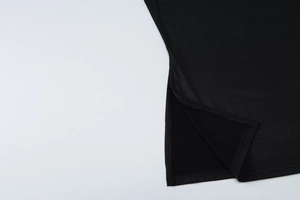 Close-up of black fabric texture and high-quality stitching on the skirt hem