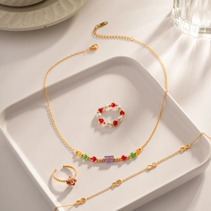 Detailed set of gold beaded necklaces, floral open rings and infinity symbol bracelets