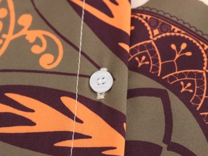 Detail view of beach set fabric with orange abstract patterns and white button stitching