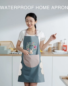 Close-up of waterproof grey apron with pink pocket and rabbit print in kitchen setting